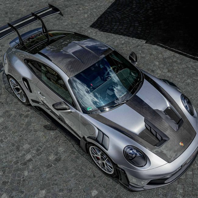 Silver Sports Car with Carbon Elements and Rear Spoiler on Cobblestones in Kitzbühel