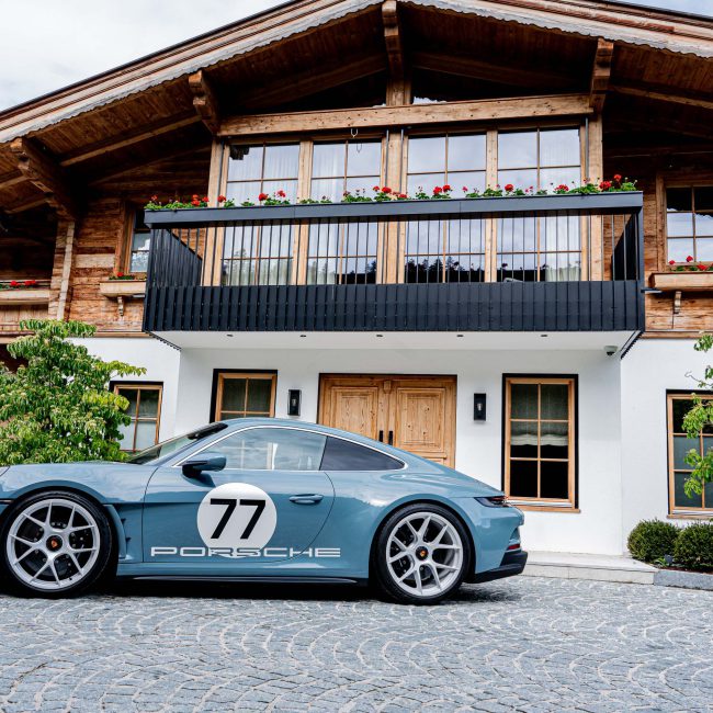 Blue Porsche Sports Car in Front of a Luxurious Chalet in Kitzbühel, Luxury Cars and Premium Vehicles