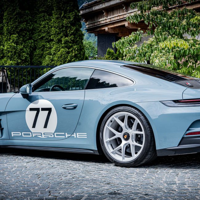Light Blue Porsche Sports Car with Race Number 77 in Front of a Villa, Luxury Cars Kitzbühel, Car Deluxe